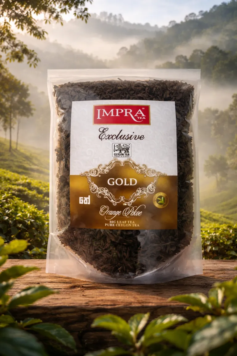 A package of Impra Gold Big Leaf tea sits on a wooden surface surrounded by green tea plants.