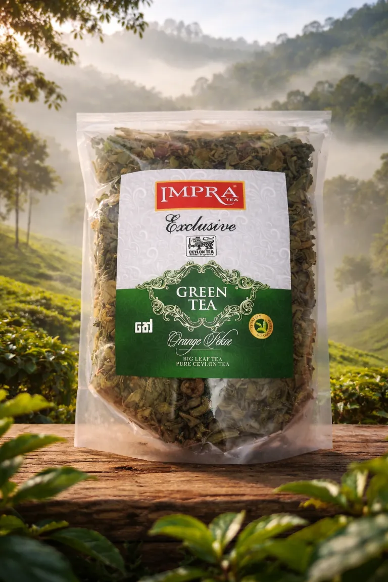 A package of Impra Exclusive Orange Pekoe Green Tea sits on a wooden surface with green tea plants in the background.
